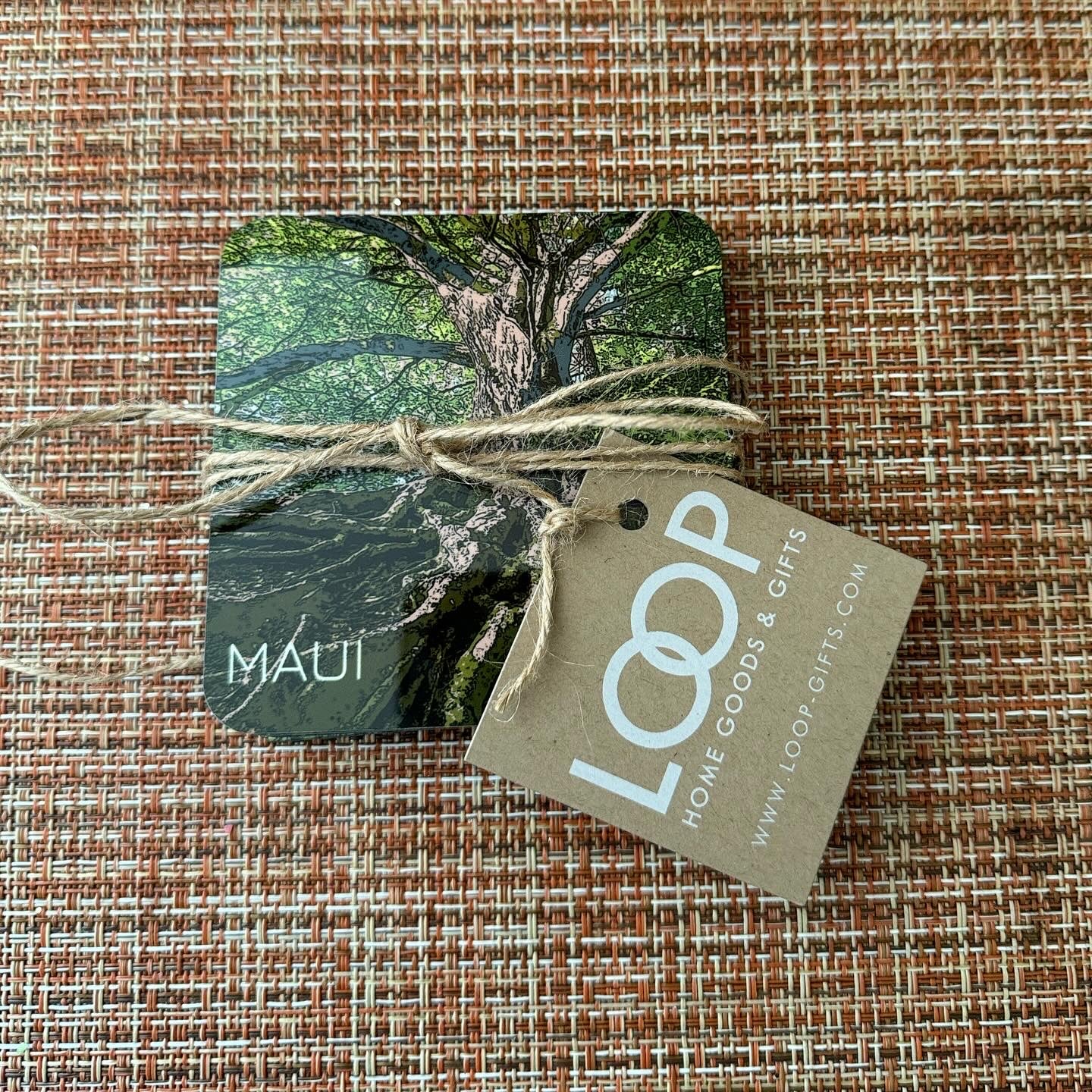 Set of 4 coasters with vibrant banyan tree design, hard acrylic surface with cork backing.